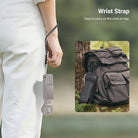 The wrist strap secures the handheld camera to prevent accidental drops during outdoor use.